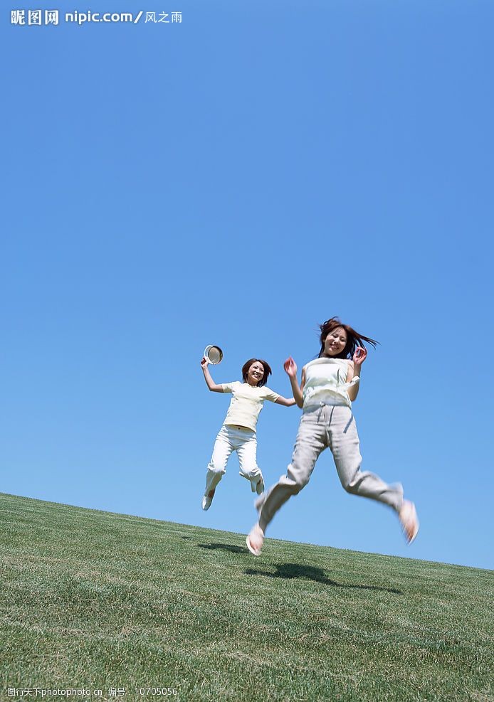 少女在草地上跳跃图片